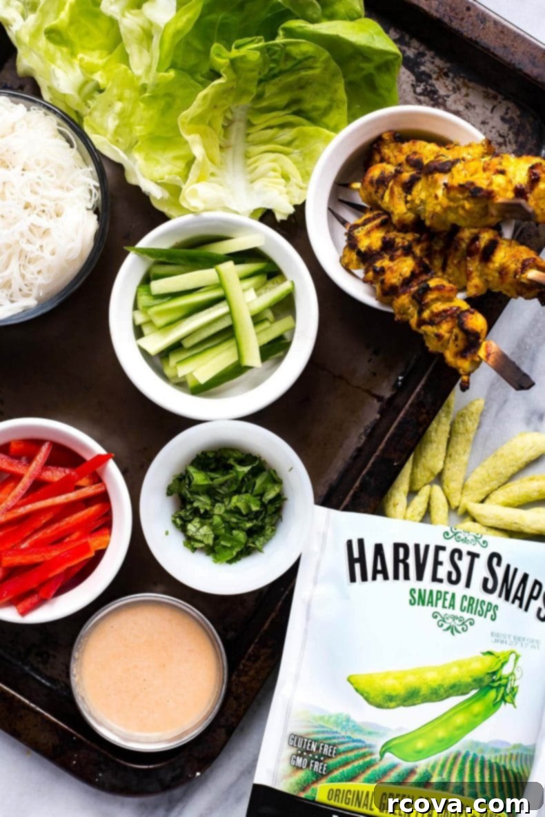 Crisp Chicken Satay Lettuce Wraps 4 Prepared ingredients for Chicken Satay Lettuce Wraps including marinated chicken skewers, fresh vegetables, and peanut sauce.