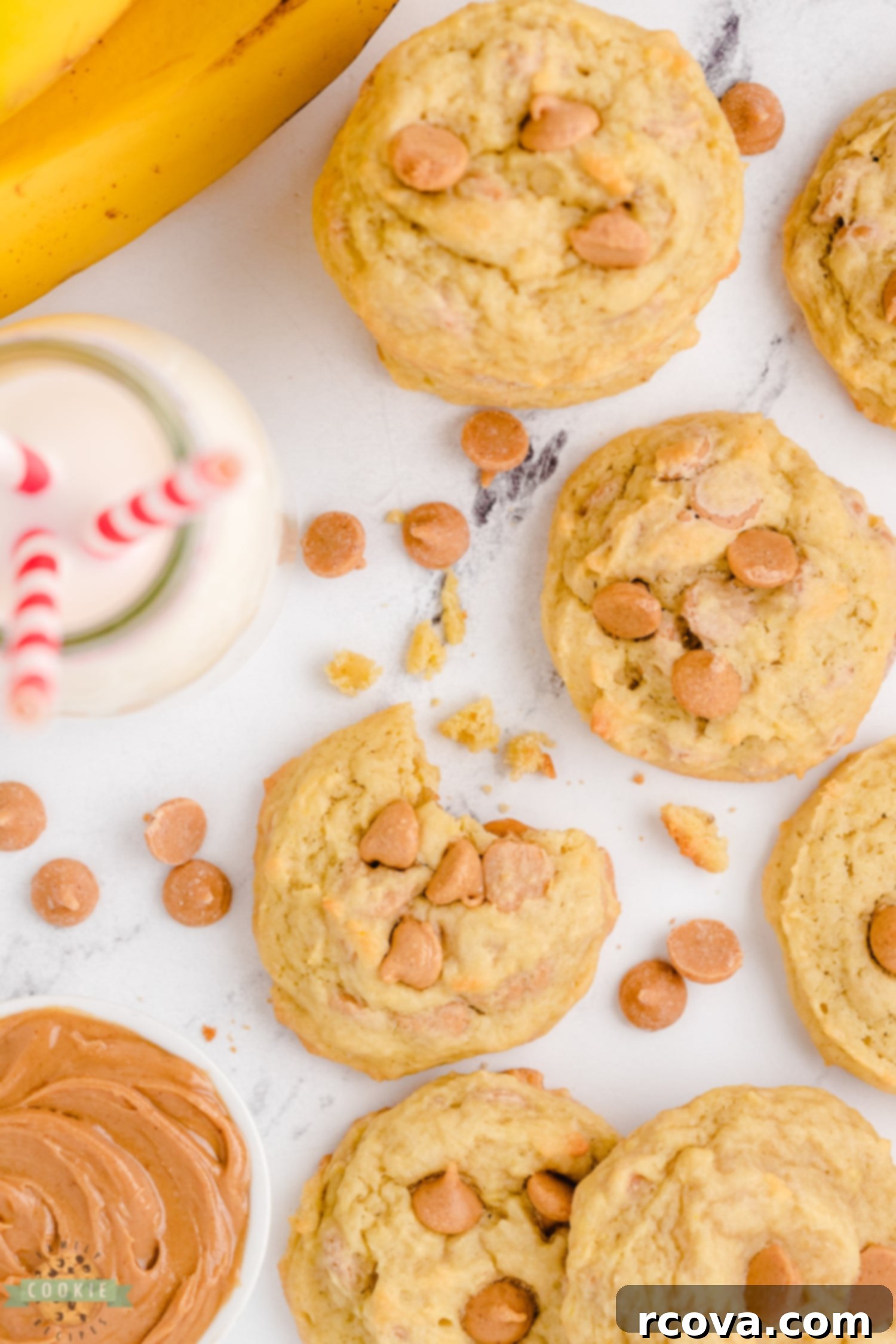 Peanut Butter Banana Bliss Bites 2 Peanut Butter Banana Pudding Cookies arranged artfully on a white surface, showcasing their golden-brown edges and soft centers.