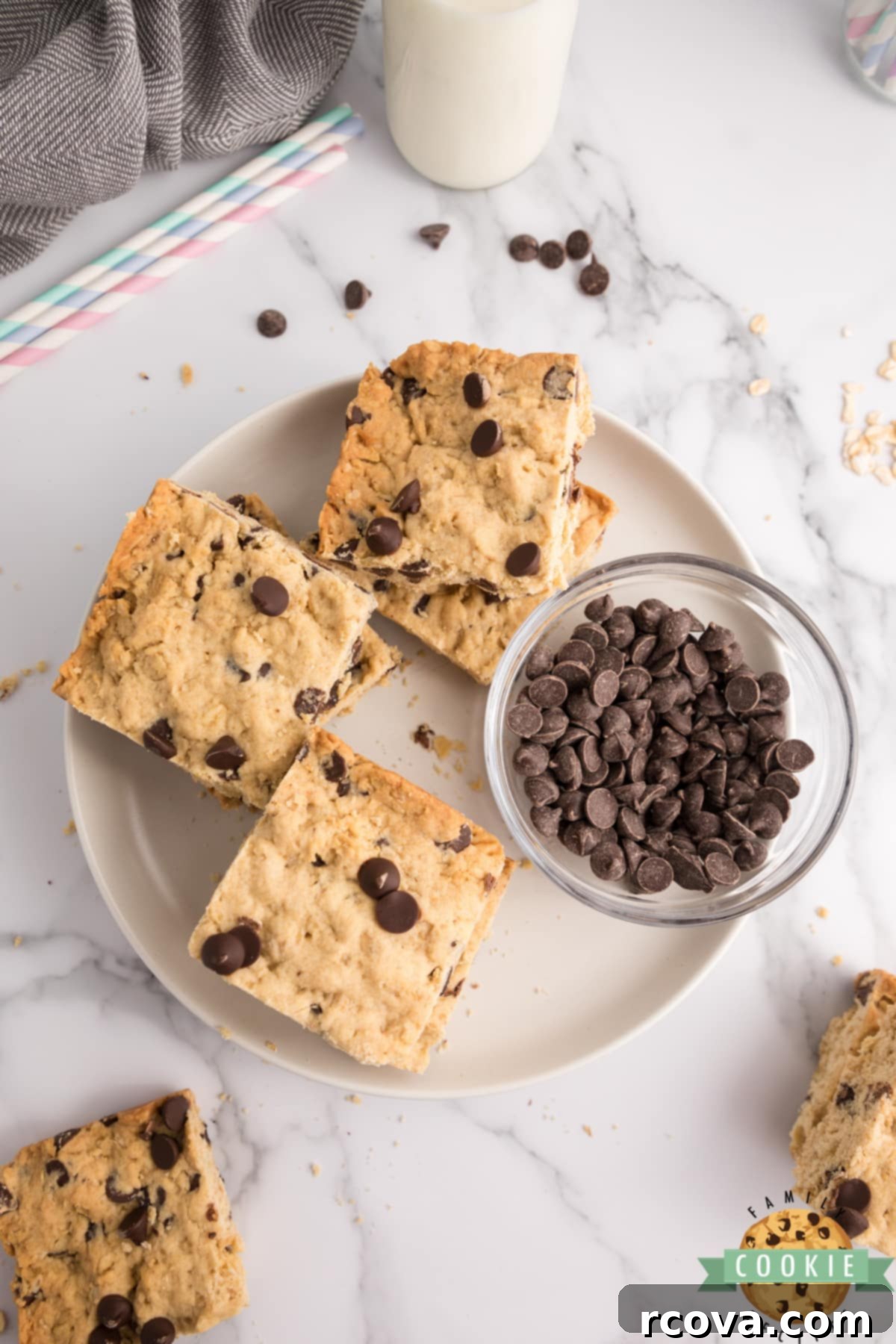 Oatmeal Chocolate Chip Delights 6 A hand reaching for a warm Oatmeal Chocolate Chip Bar in a baking pan, showing the soft, irresistible texture.