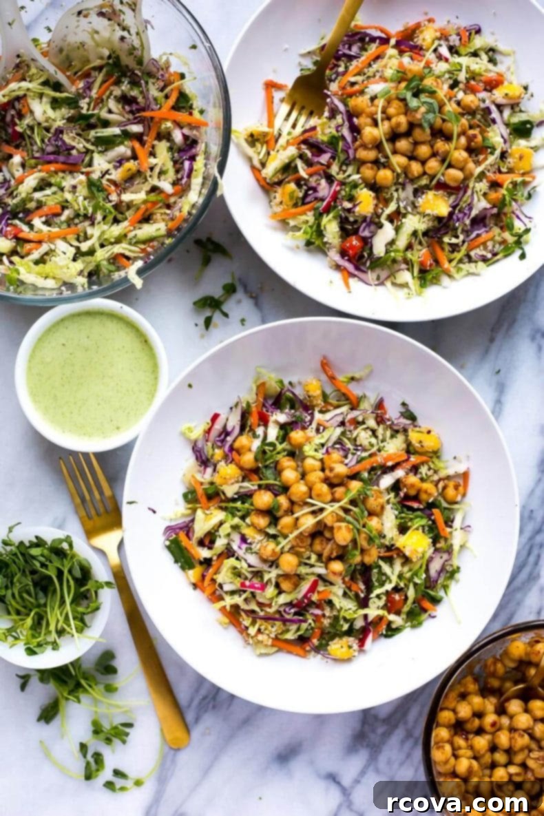 Energizing Chickpea Quinoa Salad 6 An overhead shot of the fresh and colorful Chickpea Quinoa Power Salad with Jalapeno Dressing, featuring a vegetarian rainbow slaw, sweet diced mango, and chili lime chickpeas, ready to be enjoyed.