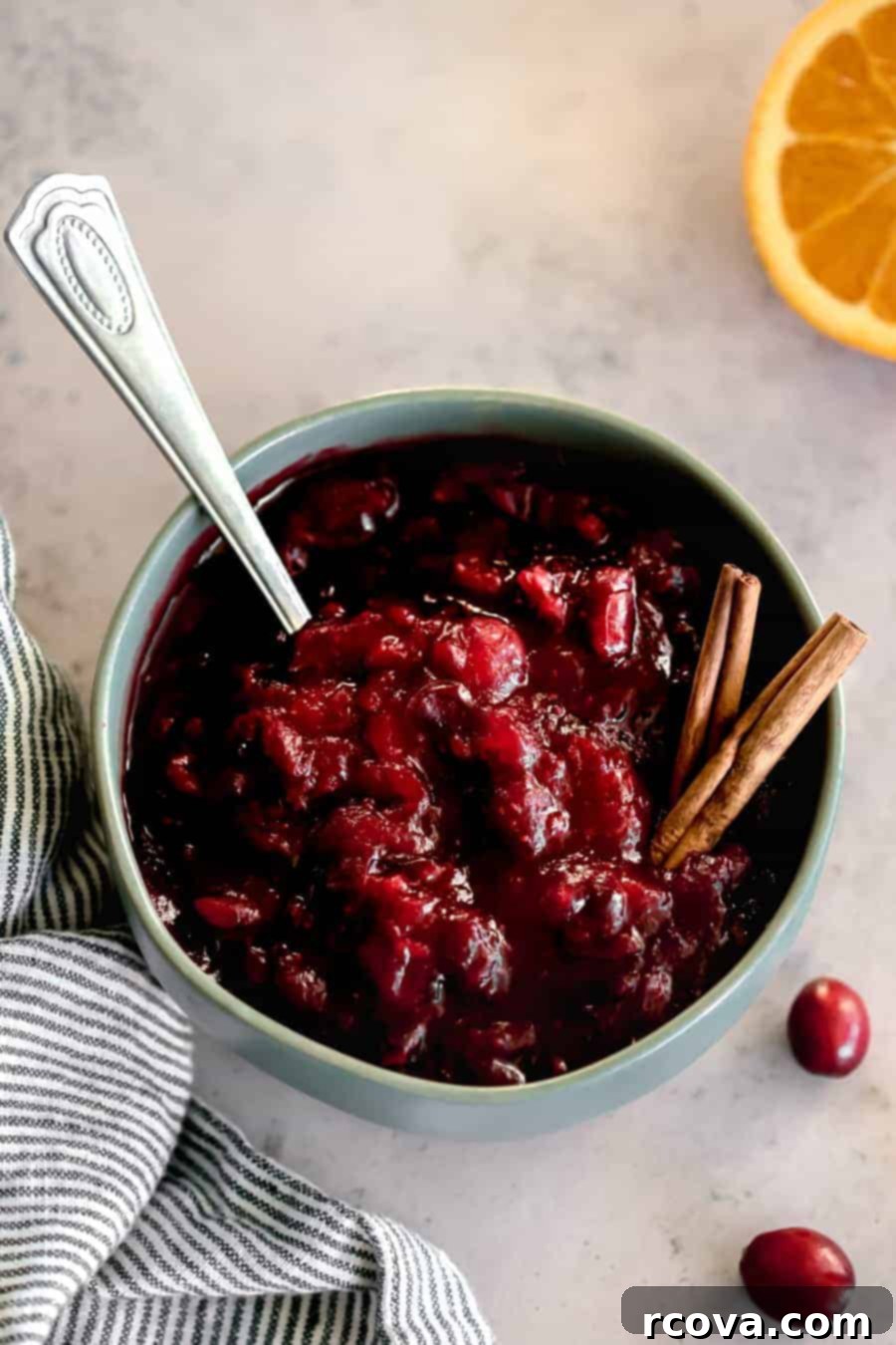 Honey-Kissed Orange Cranberry Sauce 2 A beautifully homemade cranberry sauce in a teal bowl, ready to be served.