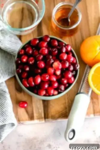 Honey-Kissed Orange Cranberry Sauce 4 Ingredients being combined in a saucepan for homemade cranberry sauce.