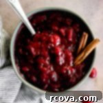 Honey-Kissed Orange Cranberry Sauce 9 A close-up of delicious homemade cranberry sauce in a teal bowl.