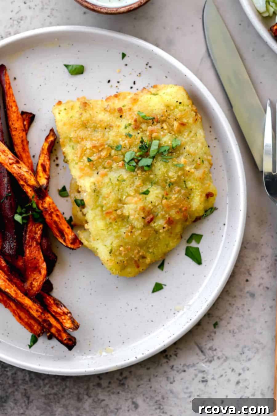 Crispy Air Fryer Frozen Cod 6 Plated Air Fryer Cod with a side of golden sweet potato fries and a fresh lemon wedge.