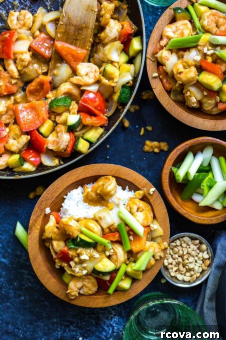 This 30-Minute Kung Pao Shrimp is a delicious, quick and easy stir fry that's perfect for getting dinner on the table quickly! Switch up the veggies to use whatever's leftover in your fridge! A plate of delicious 30-minute Kung Pao Shrimp dinner, garnished with fresh scallions and peanuts, served alongside perfectly cooked jasmine rice.