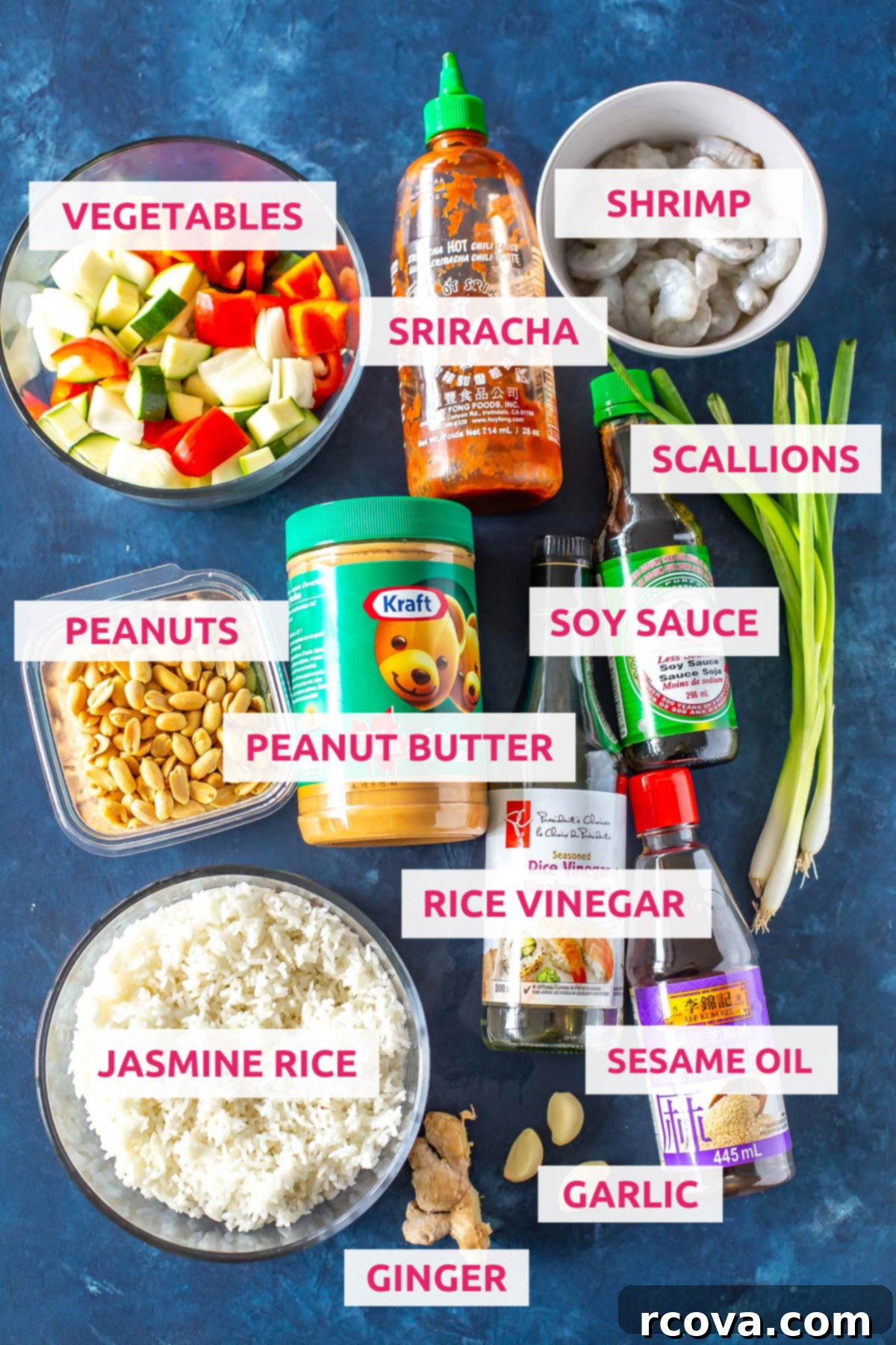 Easy 30-Minute Kung Pao Shrimp 3 A vibrant flat lay showcasing all the fresh ingredients for Kung Pao Shrimp: succulent shrimp, colorful bell peppers, zucchini, yellow onion, a bowl of rich Kung Pao sauce, alongside jasmine rice, peanuts, and fresh ginger and garlic.