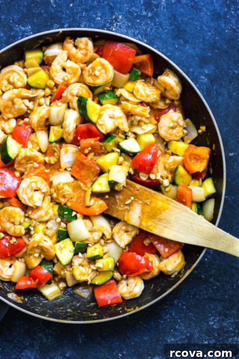 Easy 30-Minute Kung Pao Shrimp 7 A beautifully presented bowl of 30-Minute Kung Pao Shrimp, garnished with fresh herbs and peanuts, showcasing the rich sauce and perfectly cooked shrimp.
