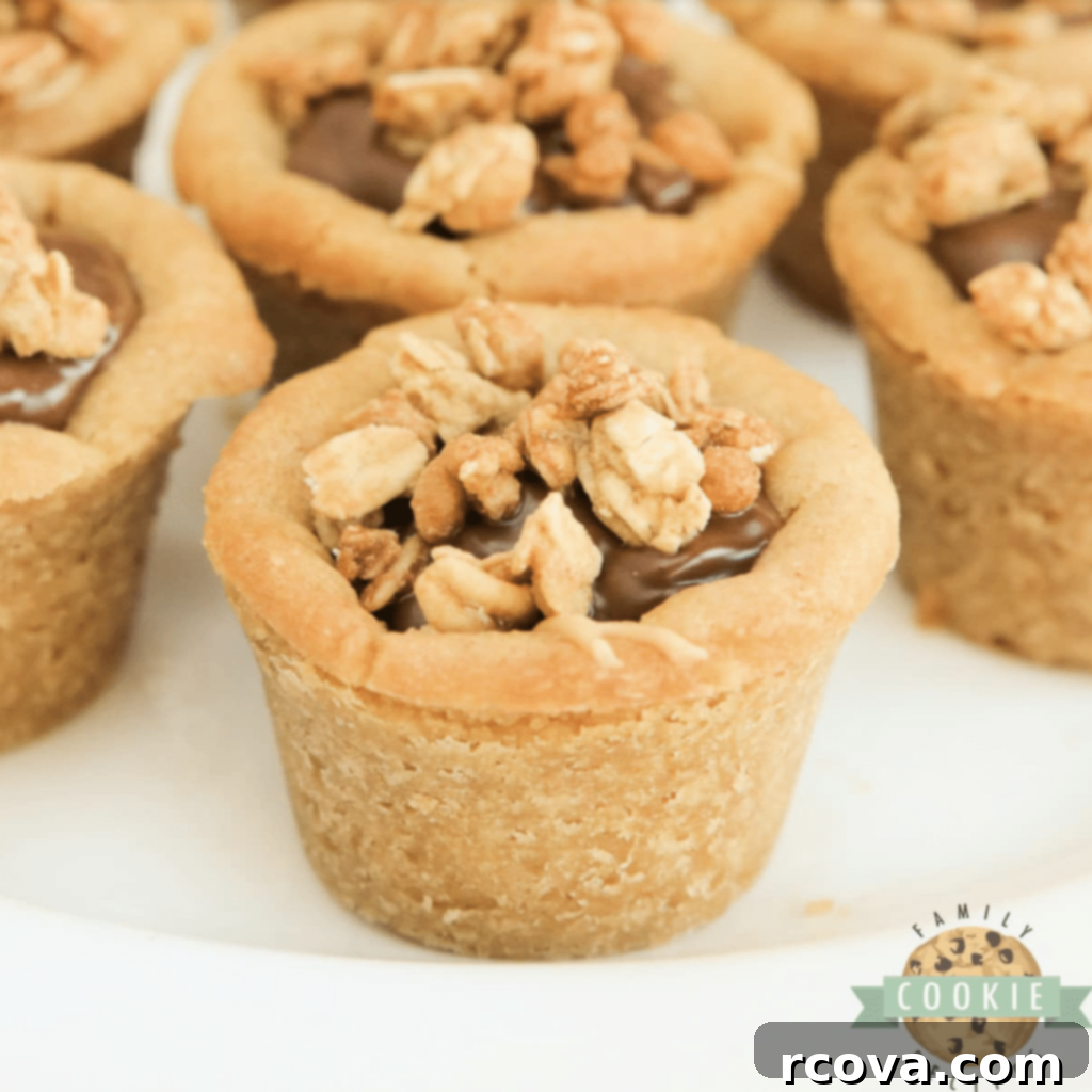 Peanut Butter Cookie Bliss 13 Easy 5-ingredient Chocolate Peanut Butter Cookie Cups with layers of creamy peanut butter and chocolate, topped with granola.