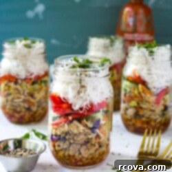 Effortless Chicken Spring Roll Jars 10 Three chicken spring roll jars in the background with one chicken spring roll jar in the foreground.