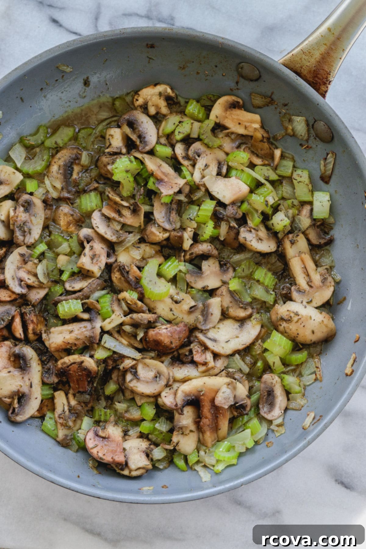 Stress-Free Slow Cooker Mushroom Stuffing 6 Celery, onion, and sliced mushrooms sautéing in a skillet, turning soft and translucent.