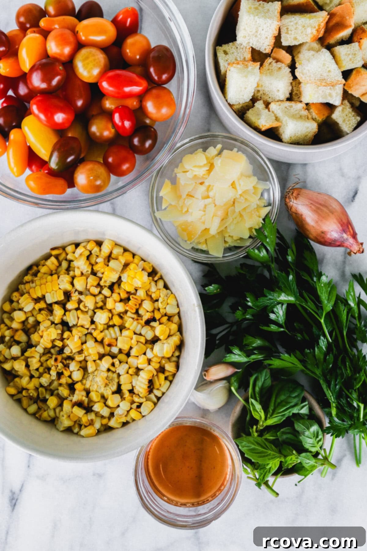 Smoky Corn and Tomato Panzanella 3 Close-up shot of the fresh ingredients for Charred Corn and Tomato Panzanella Salad, showing halved cherry tomatoes and corn kernels.