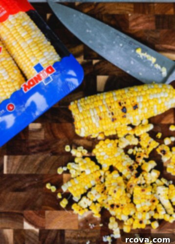 Smoky Corn and Tomato Panzanella 5 Corn on the cob charring on a grill, showing smoky marks.