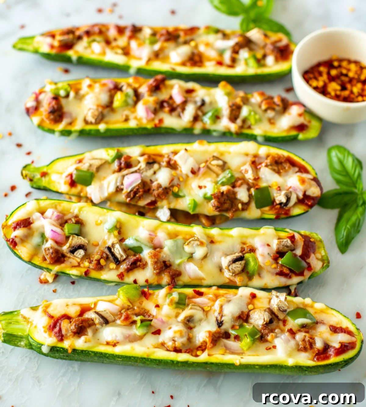Quick Zucchini Pizza Boats 8 Two perfectly baked zucchini pizza boats, generously loaded with colorful toppings and melted cheese, ready to be enjoyed as a healthy and delicious meal.