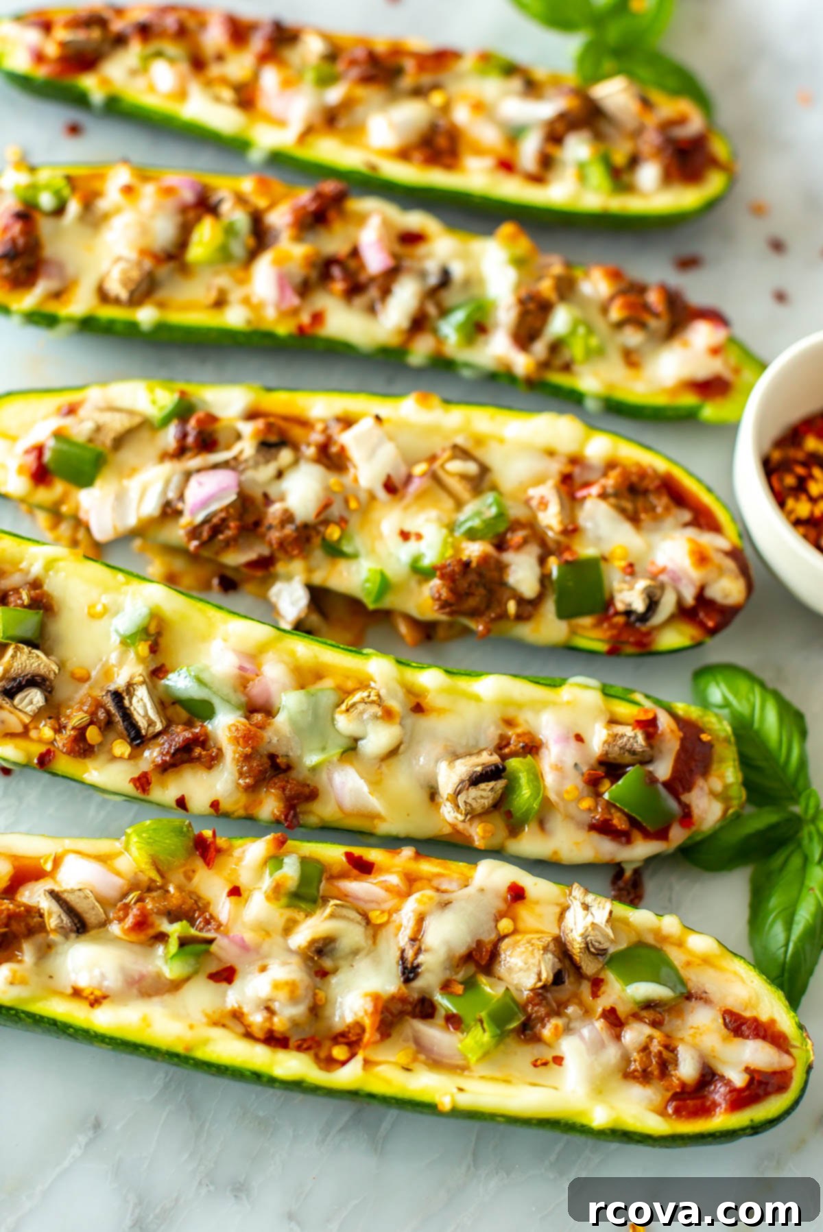 Quick Zucchini Pizza Boats 9 A perfectly arranged row of zucchini pizza boats, showcasing their colorful toppings and delicious potential for a healthy meal.
