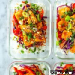 Grab-and-Go Sweet Chili Chicken Bowls 11 Four meal prep containers with sweet chili chicken inside, perfectly arranged for a balanced and delicious make-ahead meal.