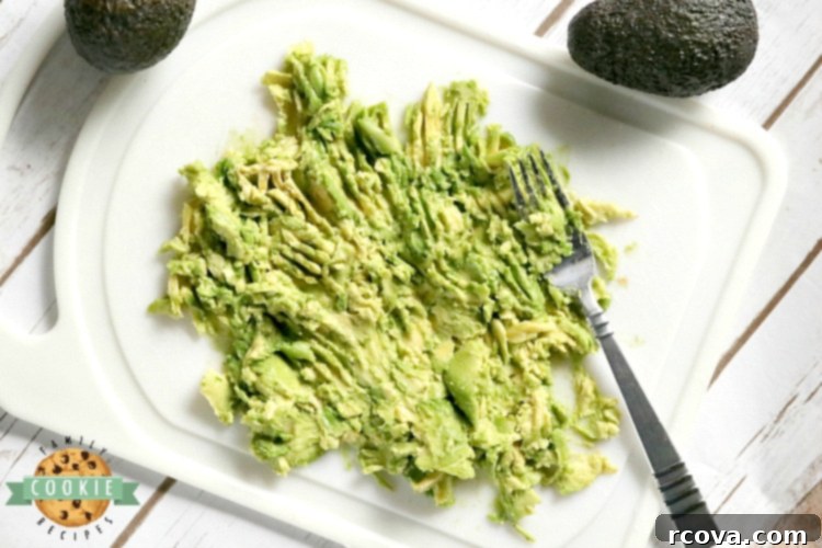 Fudgy Avocado Chocolate Chip Cookies 6 Freshly mashed avocado in a bowl, ready to be incorporated into the cookie dough, showing its vibrant green color.