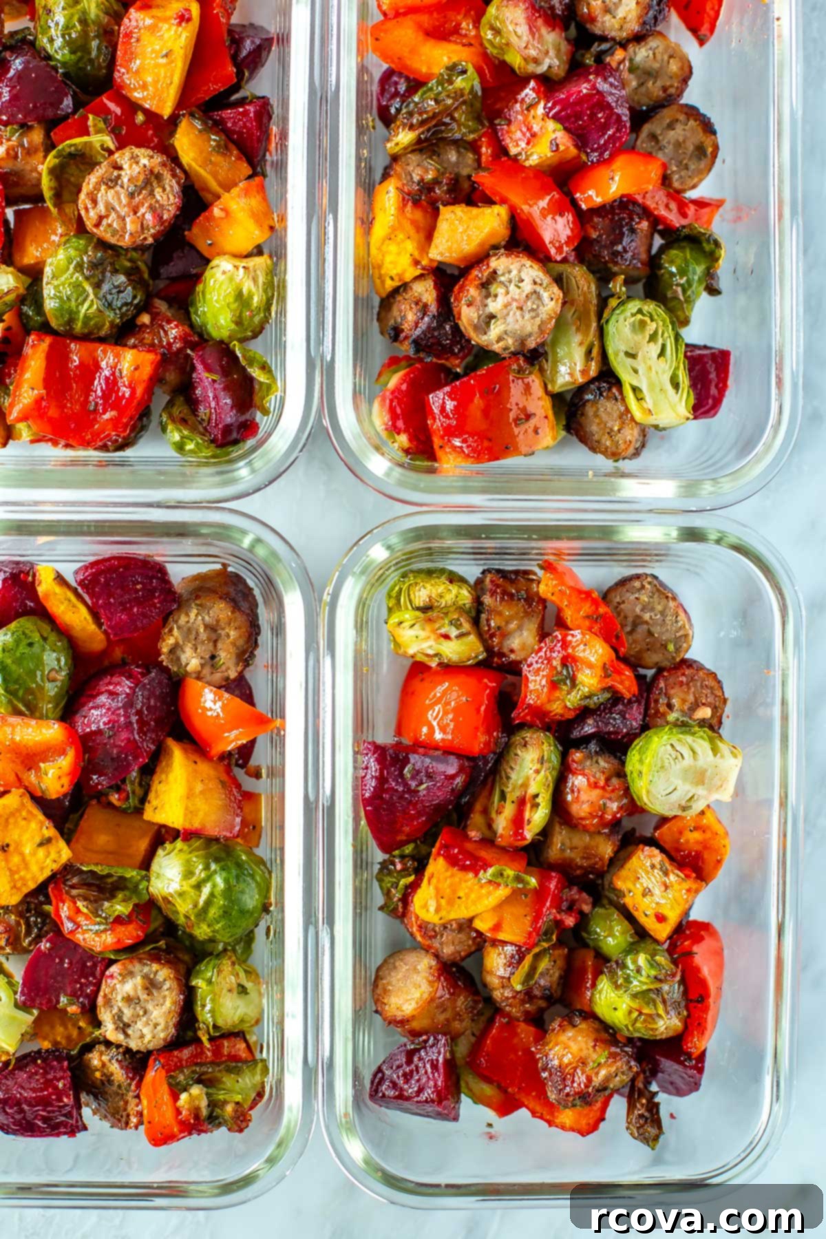 Sheet Pan Roasted Sausage and Vegetables 7 A close-up of sheet pan sausage and veggies neatly portioned into glass meal prep containers, ready for the week.