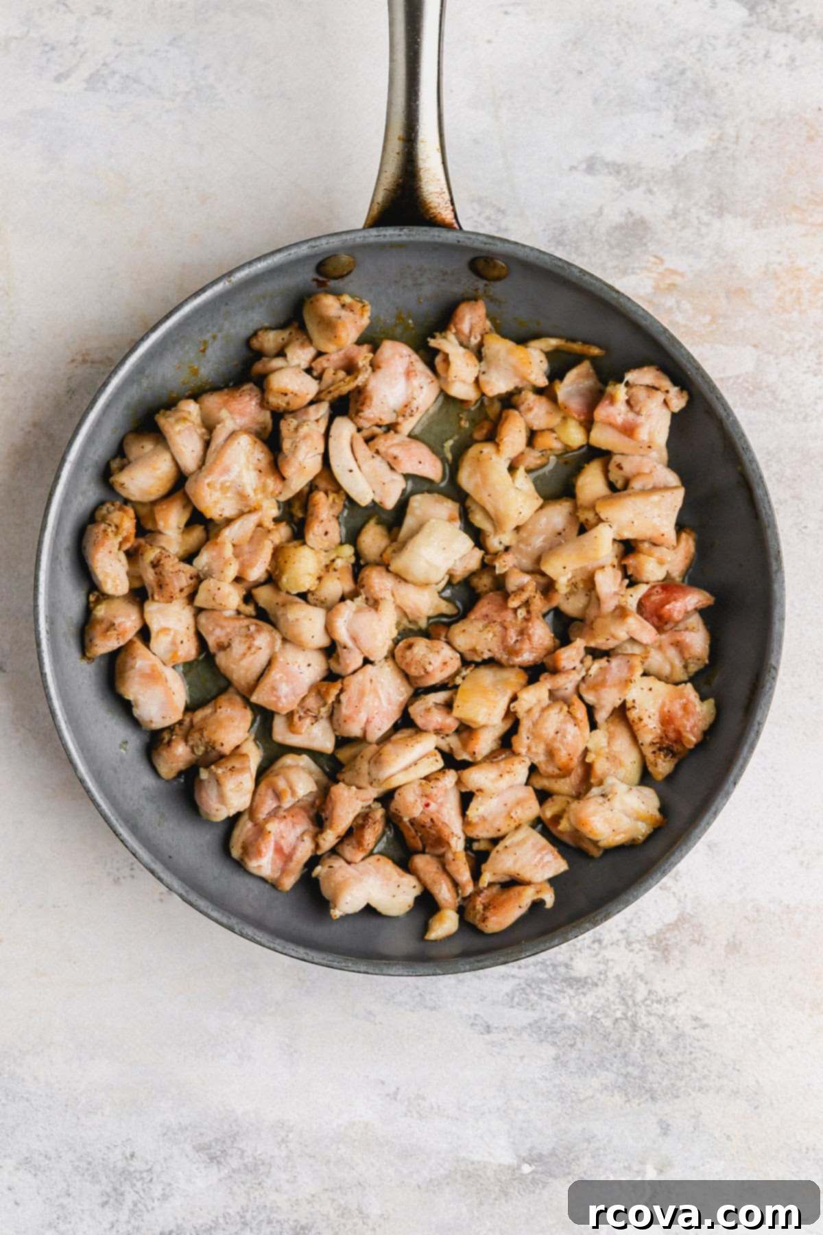 Set It and Forget It Gluten Free Dairy Free Slow Cooker Chicken Stew 5 Diced chicken pieces browning in a skillet before going into the slow cooker.