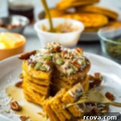 Easy 5-Ingredient Pumpkin Protein Pancakes 10 A stack of perfectly cooked 5-Ingredient Pumpkin Protein Pancakes with a light dusting of powdered sugar.