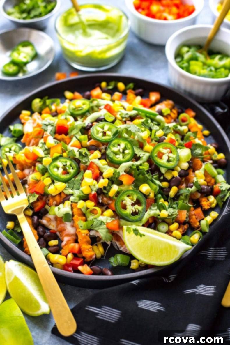 Easy Tex-Mex Sweet Potato Nacho Fries 4 Close-up of Easy Loaded Tex Mex Sweet Potato Fries with creamy sauce and fresh toppings.