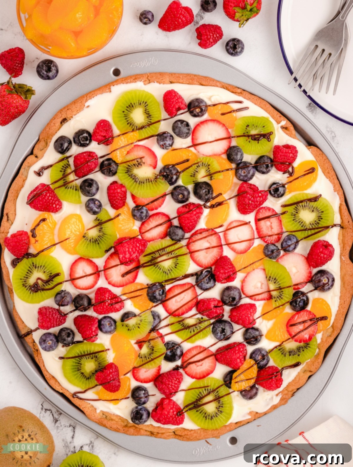 Giant Chocolate Chip Cookie Fruit Pizza 6 A freshly baked, golden brown chocolate chip cookie crust, perfectly round and cooled, awaiting its delicious toppings.