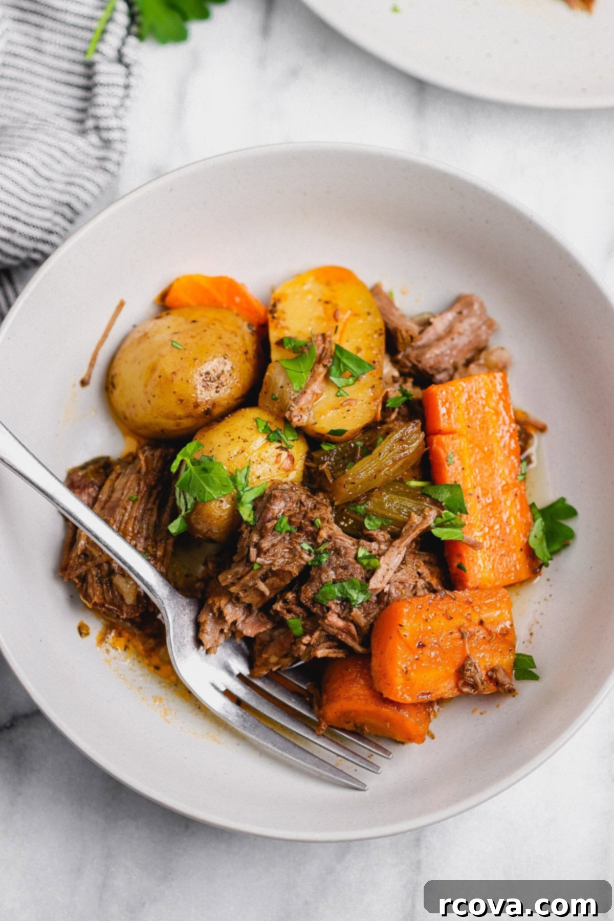 Set-It-and-Forget-It Slow Cooker Pot Roast 2 Tender chuck roast slow cooked with potatoes and carrots, ready to be served from the crock pot