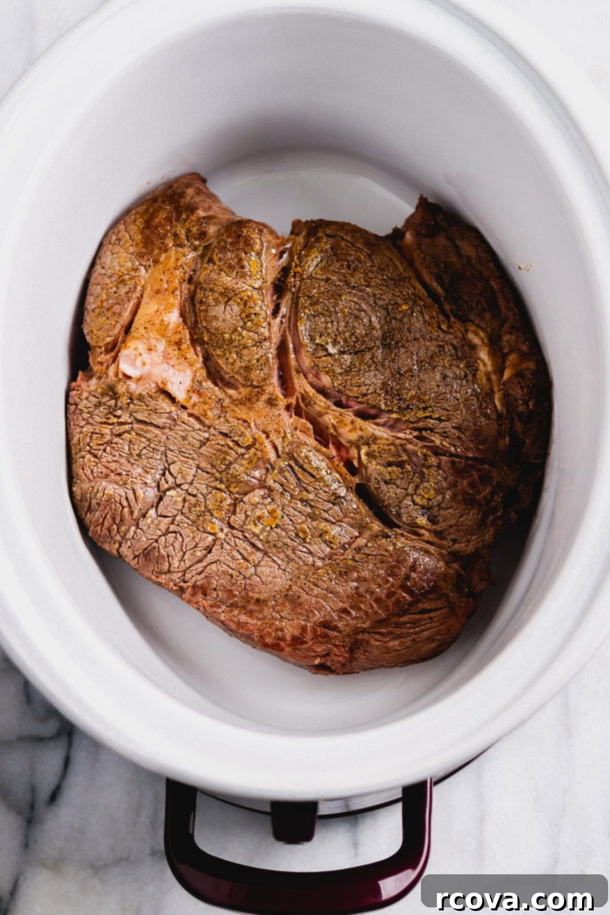 Set-It-and-Forget-It Slow Cooker Pot Roast 3 Cooked chuck roast and vegetables in a slow cooker