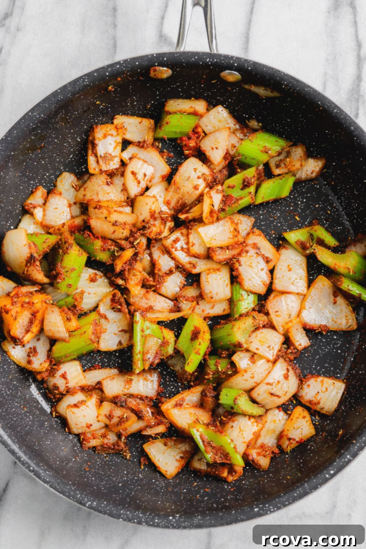 Set-It-and-Forget-It Slow Cooker Pot Roast 6 Sautéed aromatics in skillet: celery, white onion, and garlic cloves with dried spices and tomato paste