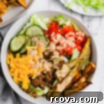 Signature Drizzle Cheesy Burger Bowls 9 Loaded burger bowl with ground beef, cheese, lettuce, and fries