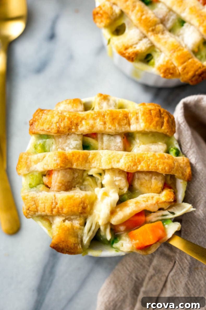Bite-Sized Chicken Pot Pie Bliss 5 Freshly baked Super Easy Mini Chicken Pot Pies with golden, flaky puff pastry crusts, served in ramekins.