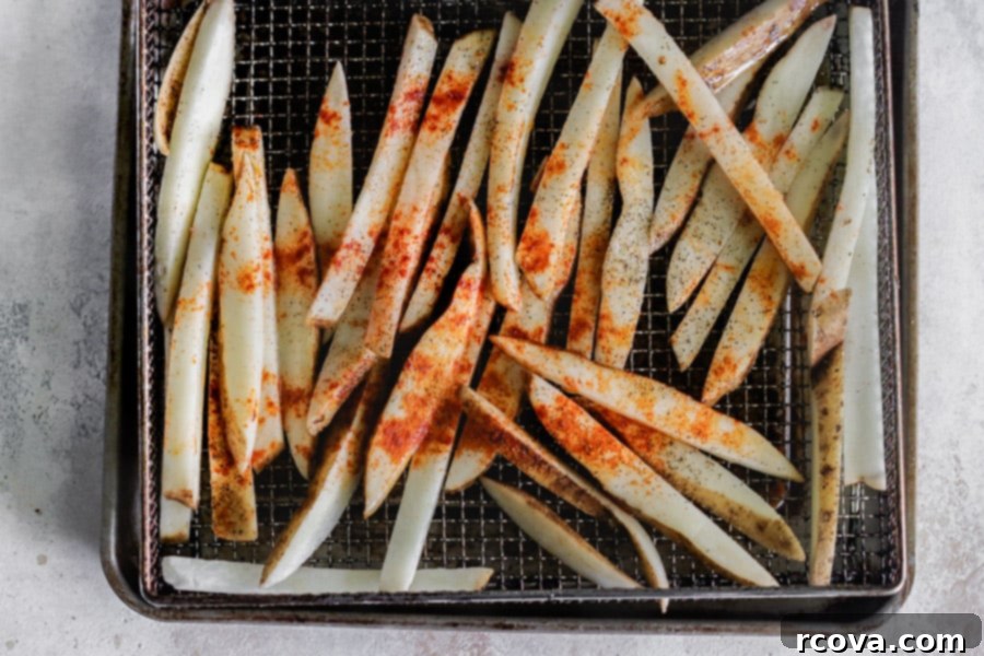 Homemade Air Fryer Fries: Perfectly Crispy 6 Seasoned potato sticks ready for the air fryer.