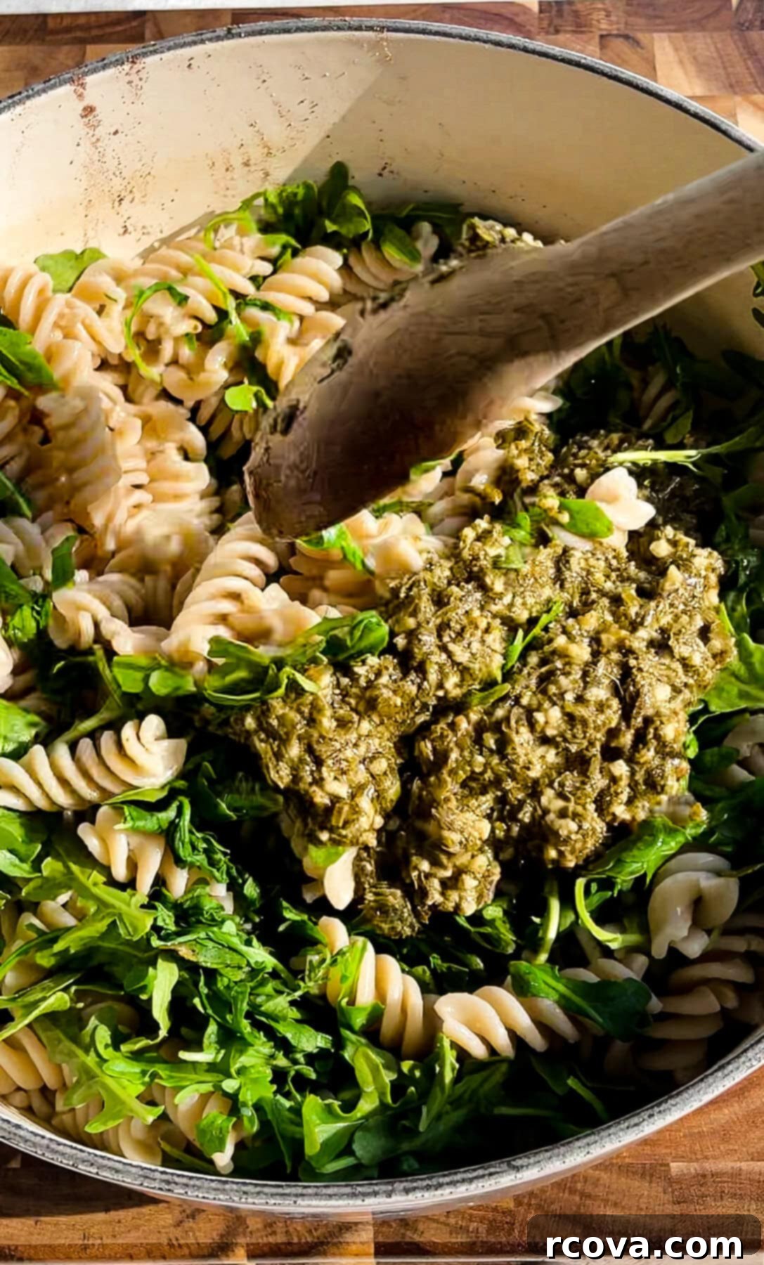 Easy Pesto Chicken Sausage Pasta 5 draining pasta over greens