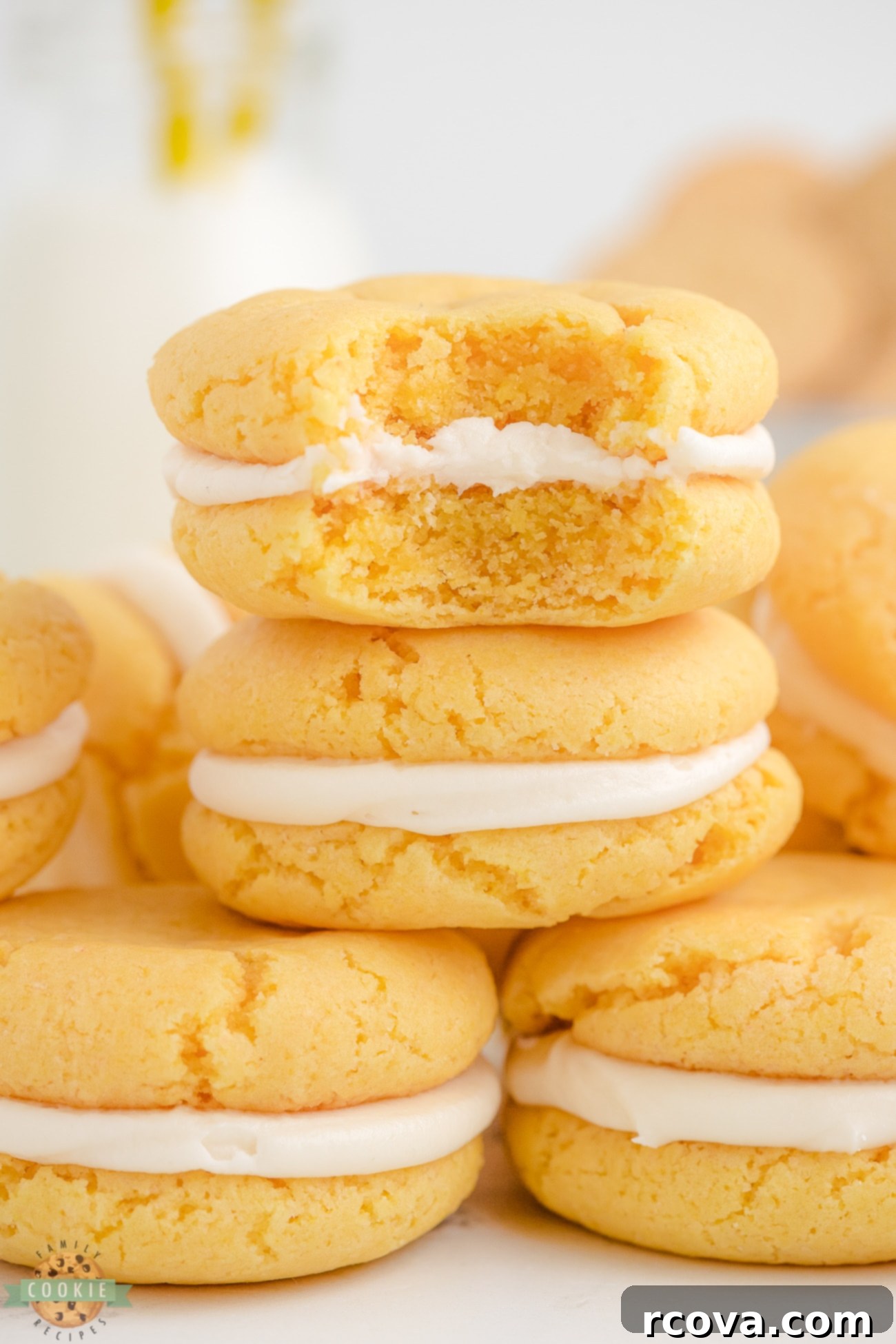 Golden Oreo Copycat Cookies 6 A bite taken out of a homemade golden oreo, showing the creamy filling