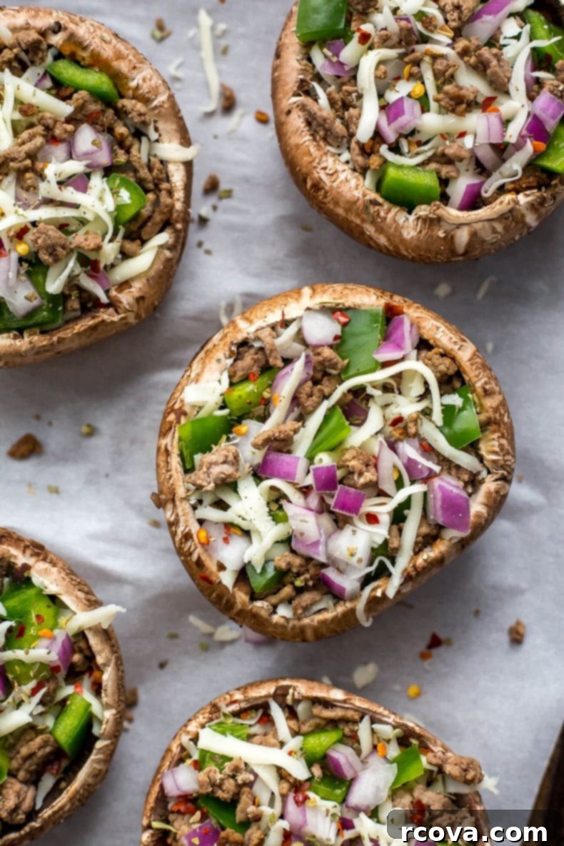 Effortless Low Carb Portobello Pizza Caps 5 A hand holding a slice of Portobello pizza, demonstrating its perfect size and deliciousness