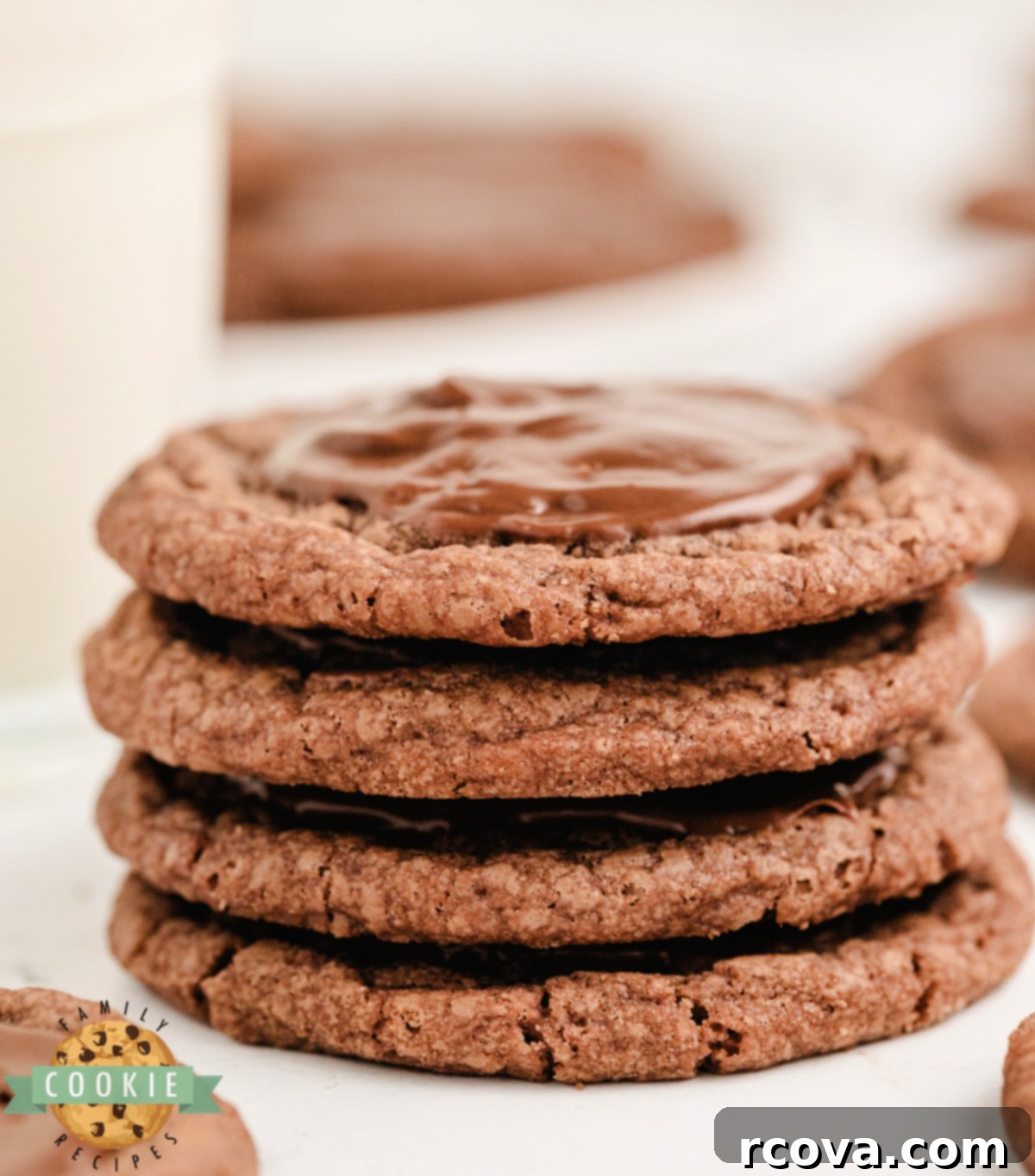 Quick Fudgy Brownie Mix Cookies 5 Stack of brownie mix cookies that are frosted with a melted Hershey bar.
