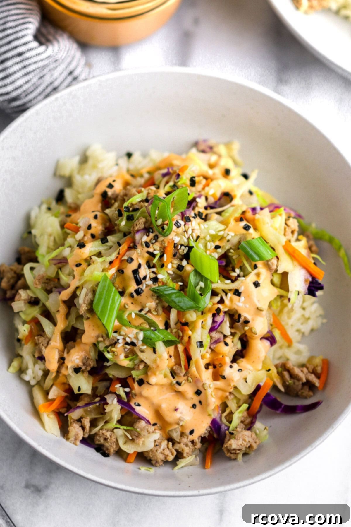 Tangy Sriracha Mayo 6 Egg roll bowl with a generous drizzle of spicy sriracha mayo.