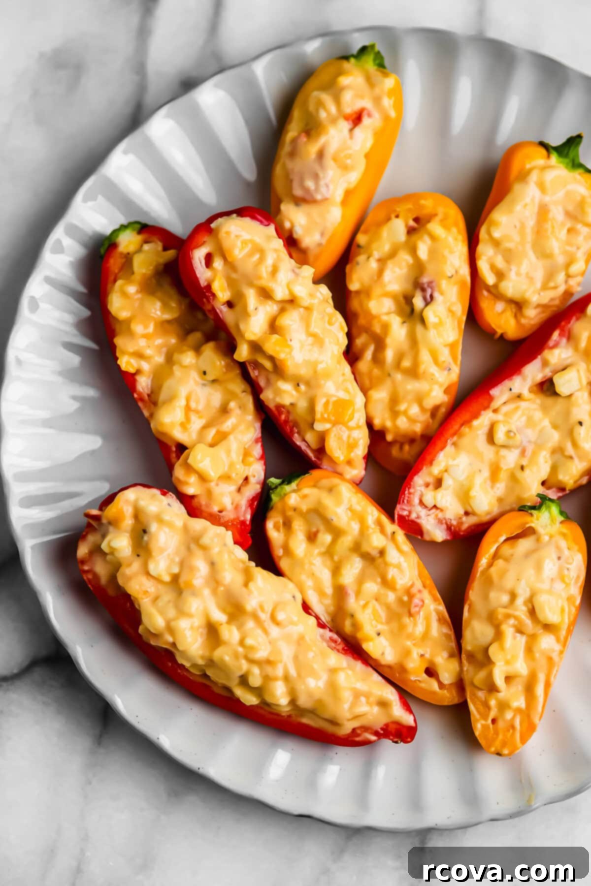 Savory Pimento Cheese Mini Pepper Poppers 6 Assortment of vibrant pimento cheese stuffed mini peppers on a platter