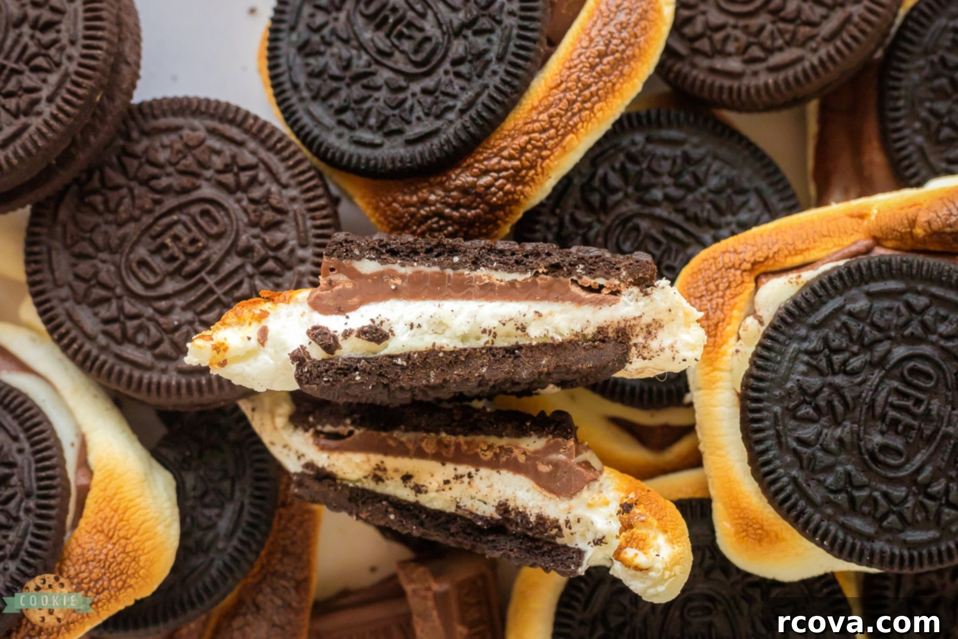 Ultimate Oreo S'mores 5 Close-up of an Oreo s'more cut in half, revealing gooey marshmallow and melted chocolate.