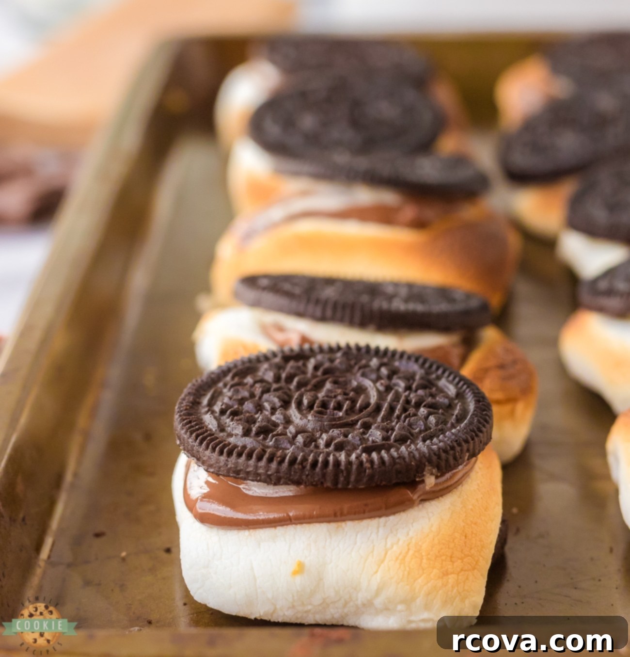 Ultimate Oreo S'mores 9 Hot Oreo s'mores on a baking pan, fresh from the oven, showing melted chocolate and toasted marshmallow.