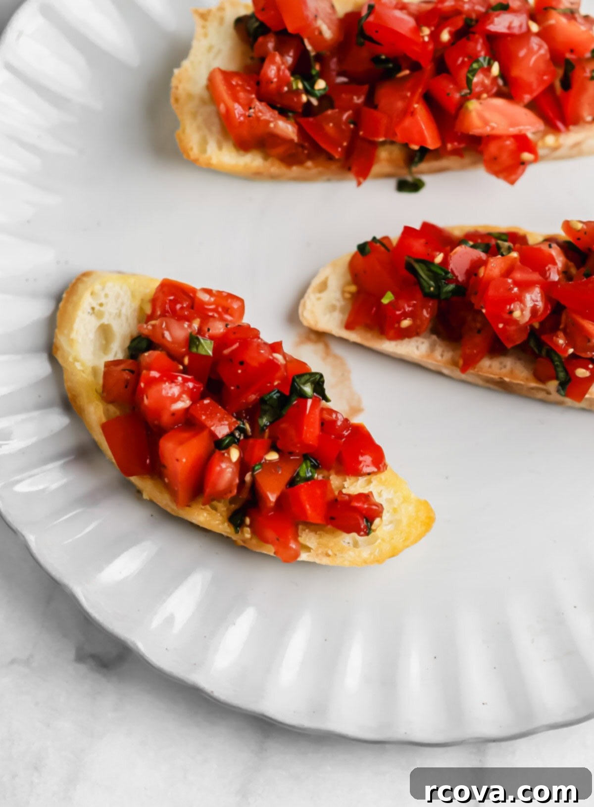 Homemade Bruschetta with a Burst of Grape and Cocktail Tomatoes 2 Classic homemade tomato bruschetta served on toasted baguette slices, garnished with fresh basil