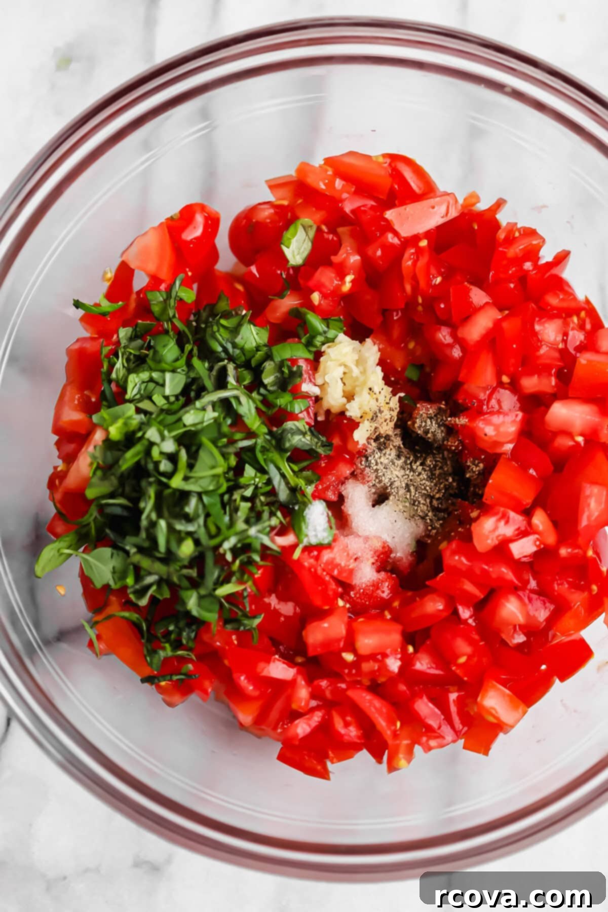 Homemade Bruschetta with a Burst of Grape and Cocktail Tomatoes 3 Close-up of fresh bruschetta topping ingredients: diced tomatoes, basil, and garlic
