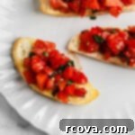 Homemade Bruschetta with a Burst of Grape and Cocktail Tomatoes 7 Simple Homemade Tomato Bruschetta on a white plate