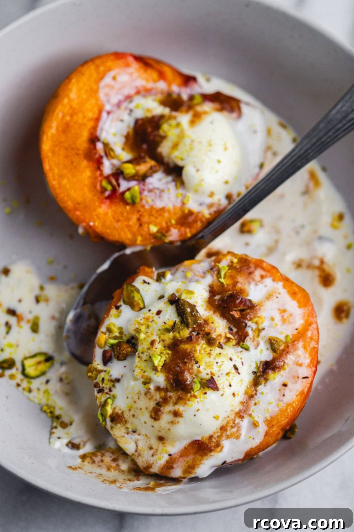 Air Fryer Peaches Simply Sweet and Speedy 2 Two halves of air fryer peaches, golden brown and caramelized, drizzled with sauce and topped with crushed nuts.