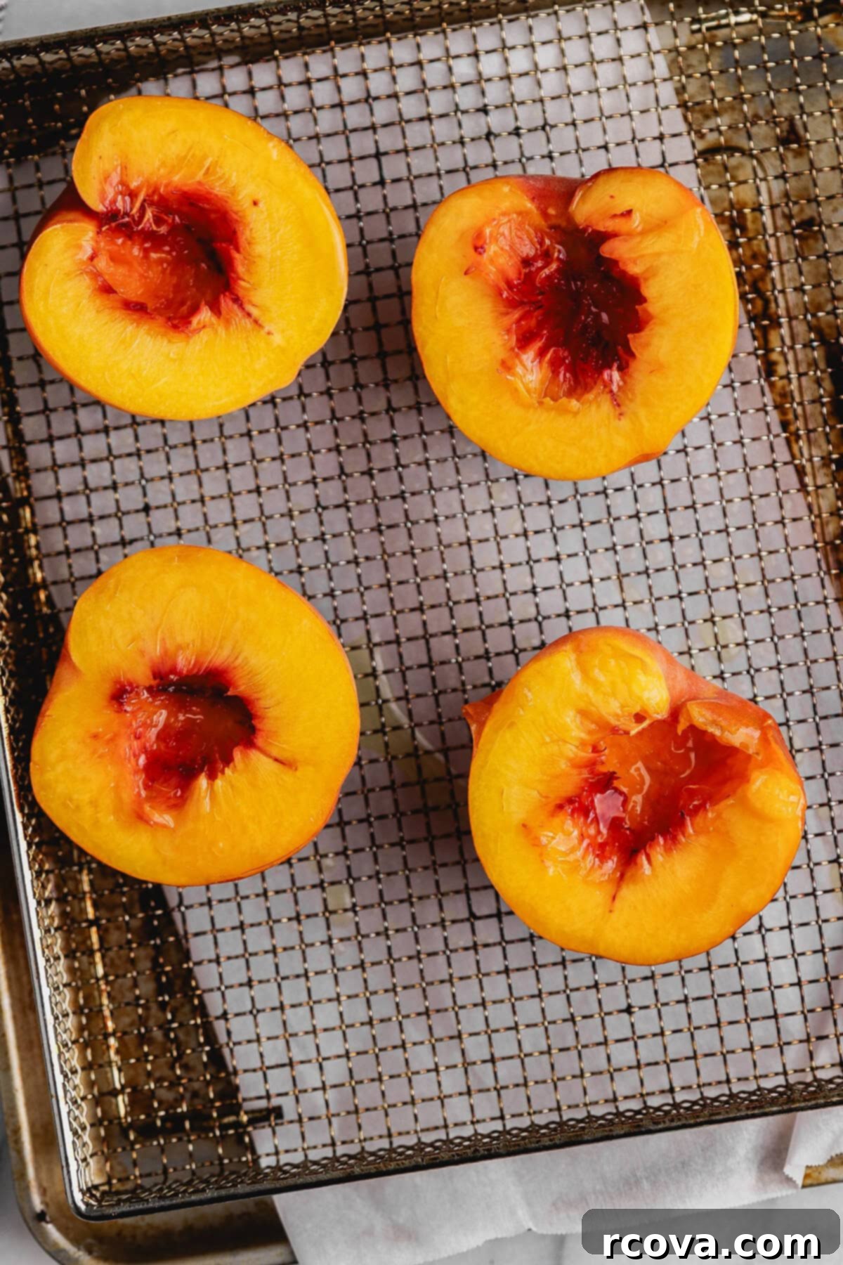 Air Fryer Peaches Simply Sweet and Speedy 5 Fresh peach halves, lightly oiled, ready to be placed in the air fryer.