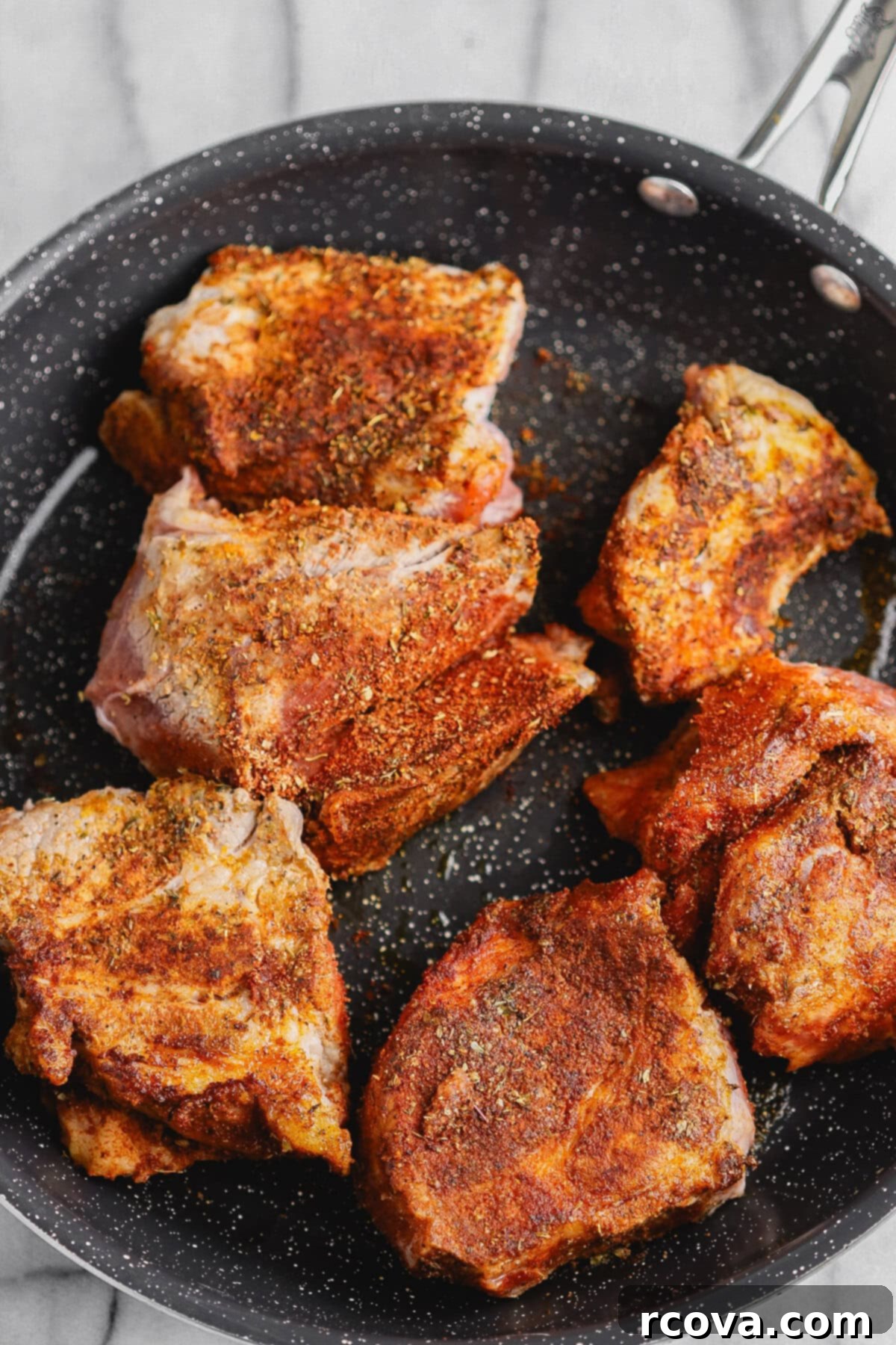 Effortless Sugar-Free Slow Cooker Pulled Pork 5 Searing seasoned Boston butt pork chunks in a hot skillet.