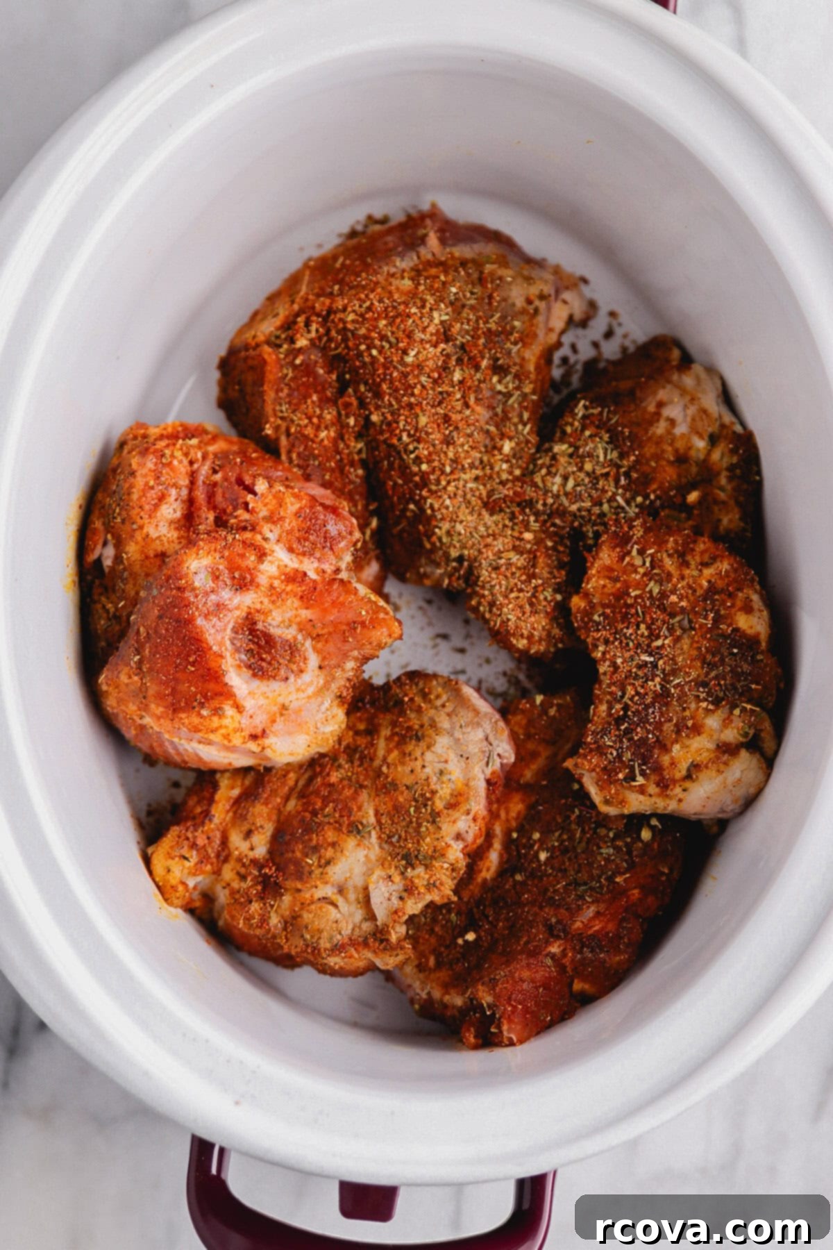 Effortless Sugar-Free Slow Cooker Pulled Pork 6 Slow cooker with seared pork chunks and liquid, ready for slow cooking.