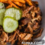 Effortless Sugar-Free Slow Cooker Pulled Pork 8 A close-up of a serving of shredded slow cooker pulled pork, garnished and ready to eat.