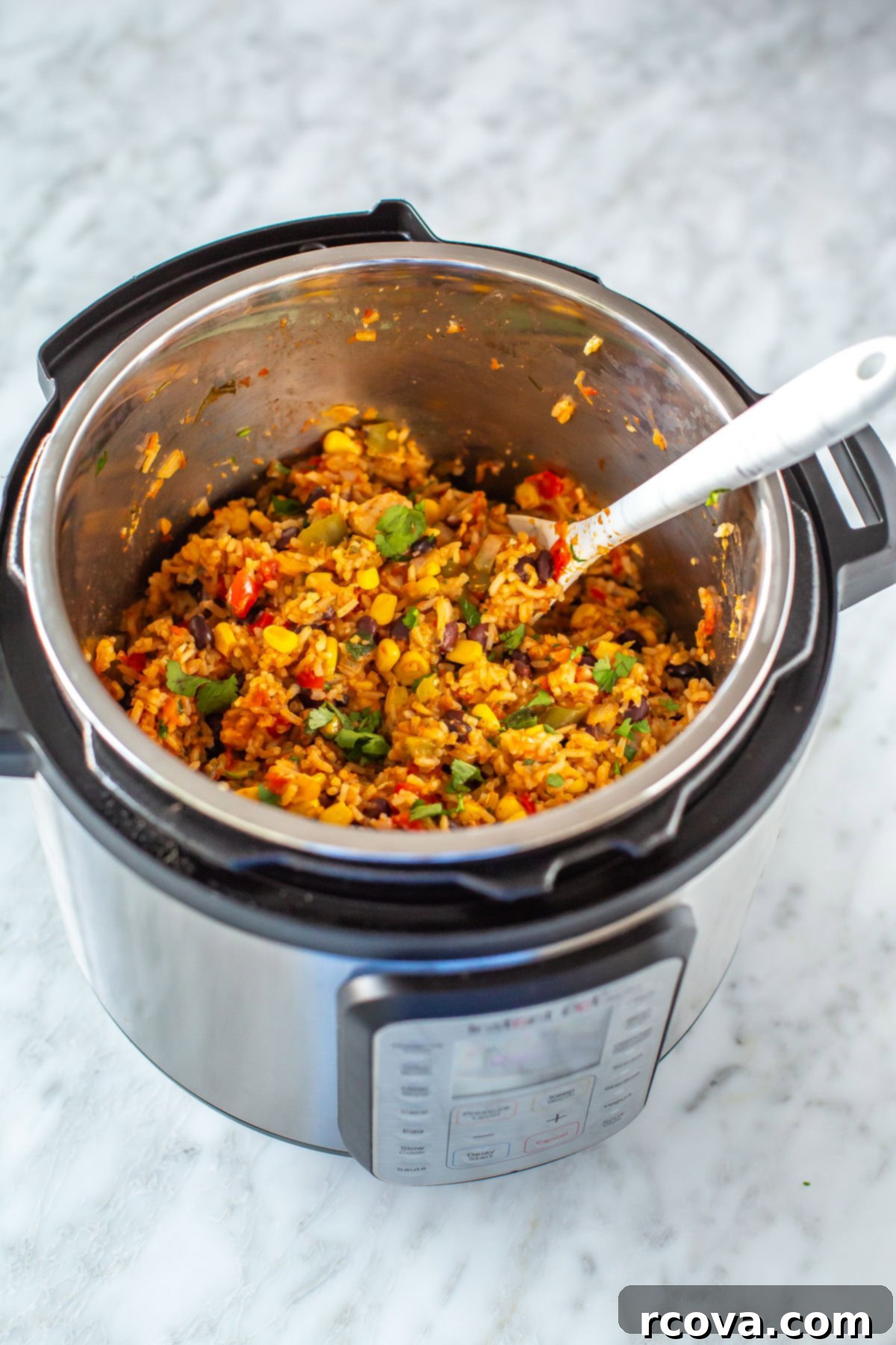 Effortless Instant Pot Chicken Burrito Bowls 7 An Instant Pot filled with cooked chicken burrito bowl mixture, ready to be served.