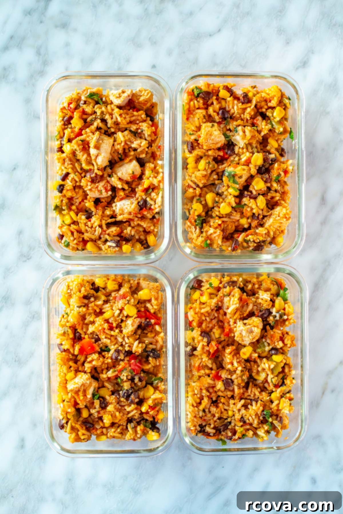 Effortless Instant Pot Chicken Burrito Bowls 9 Four meal prep containers, each with a serving of Instant Pot chicken burrito bowls, ready for the week.