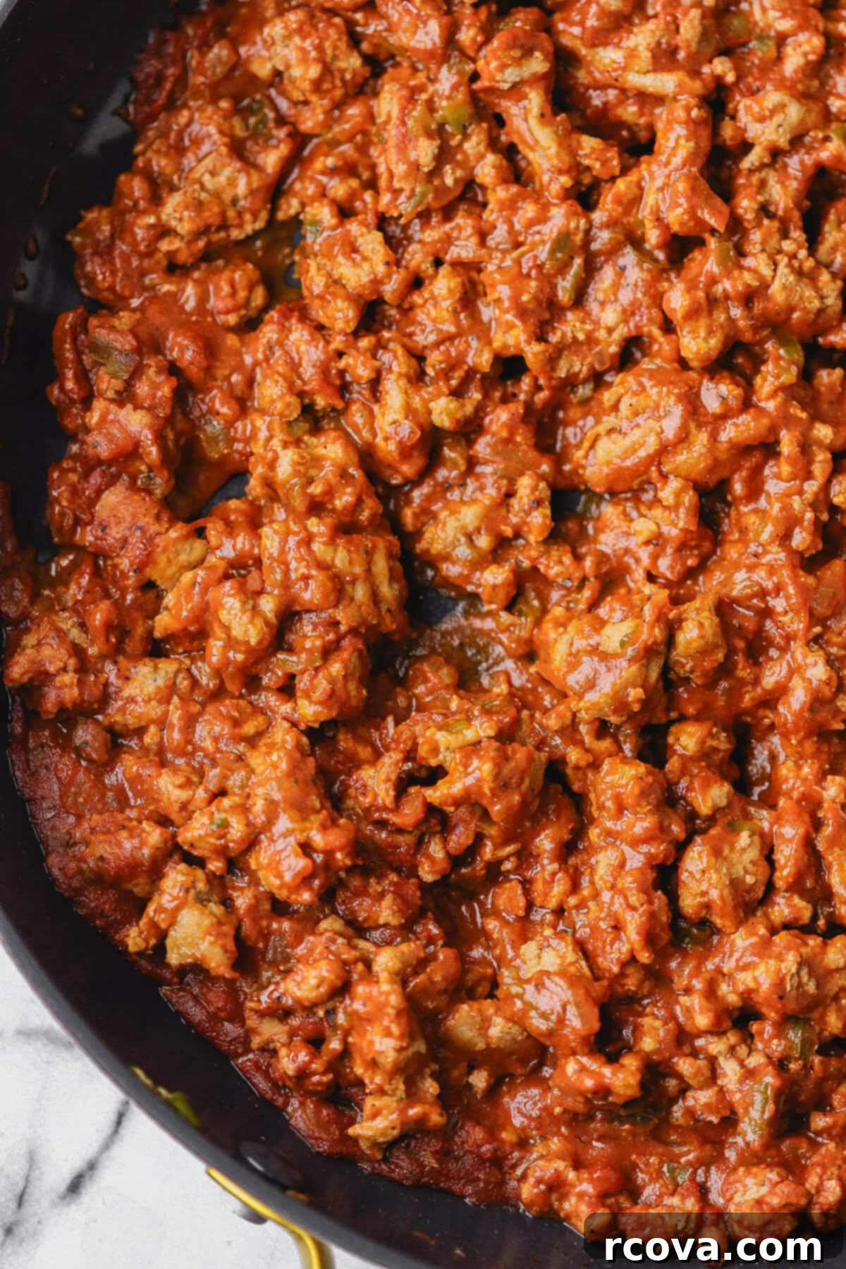 Easy Turkey Sloppy Janes 6 Adding sloppy joe sauce to ground turkey in a skillet